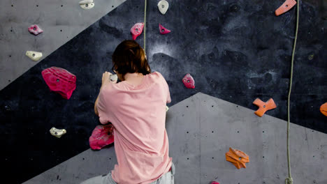 Teenage-boy-climbing-indoors