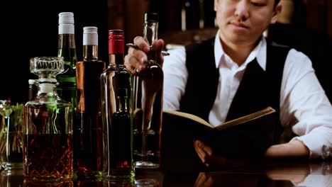 Bartender-checking-alcohol-bottles