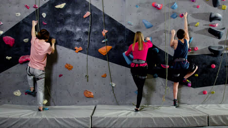 Teenage-boys-and-girl-climbing-indoors