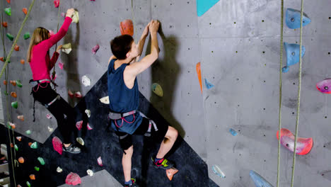 Teenage-boy-and-girl-climbing-indoors