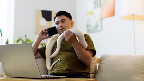 Man-with-snake-talking-on-the-phone