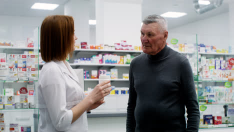 Young-woman-talking-with-senior-man-at-the-pharmacy