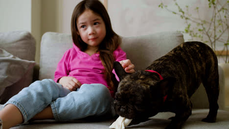 Girl-petting-dog-at-home