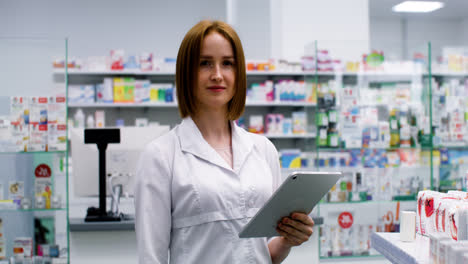 Blond-woman-with-tablet-in-a-pharmacy