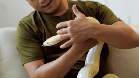 Man-with-snake-indoors