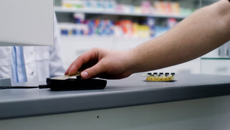 Pharmacist-putting-pills-on-the-counter