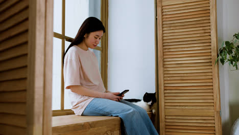 Woman-with-cat-by-the-window