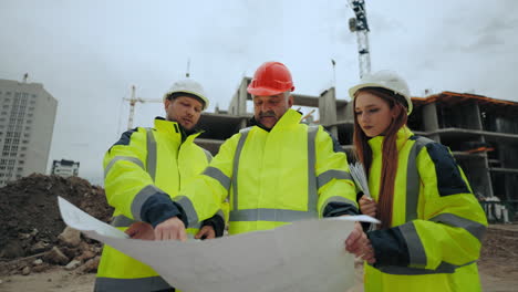 foreman-and-architects-are-viewing-construction-plan-in-building-site-engineering-group