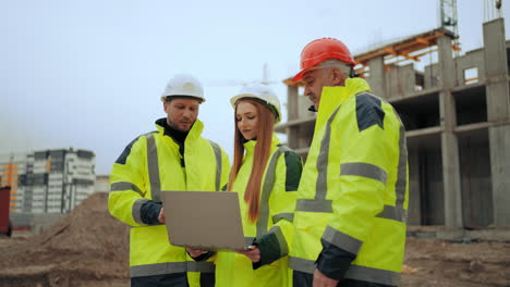 three-engineers-are-discussing-project-of-building-and-construction-progress-in-building-site