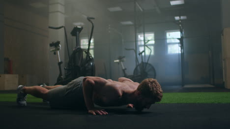 a-strong-man-performs-push-UPS-from-the-floor-with-all-his-strength.-a-pumped-up-man-does-push-UPS-in-the-gym