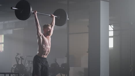 Slow-motion-of-crossfit-athlete-performs-clean-and-jerk.-Young-man-doing-the-clean-and-jerk-weightlifting-exercise-at-the-gym.