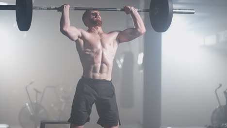 Handsome-Muscular-Man-Does-Deadlift-and-Curls-with-a-Heavy-Barbell.-Athletic-Shirtless-Man-Training-Doing-Power-Strength-and-Endurance-Exercises-with-Barbell.-Workout-in-the-Hardcore-Gym