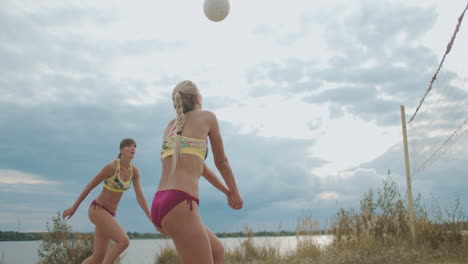 professional-beach-volleyball-female-players-are-training-on-sand-court-at-summer-passing-and-attacking-other-team