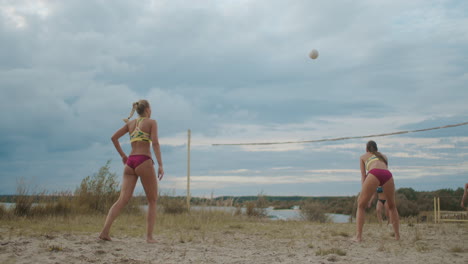 Eine-Beachvolleyballspielerin-Spielt-Den-Ball.-Zeitlupenaufnahme-Eines-Pass--Und-Angriffsspiels-Zweier-Damenmannschaften
