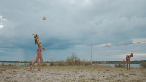 serve-pass-and-attack-at-beach-volleyball-match-between-two-women-teams-at-summer-cloudy-day-slow-motion-shot