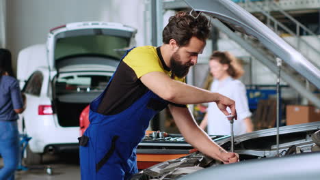 Mechanic-in-car-service-uses-wrench