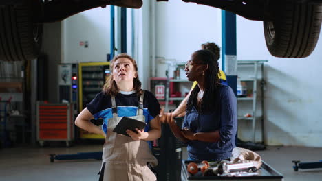 Technician-and-woman-look-for-car-parts
