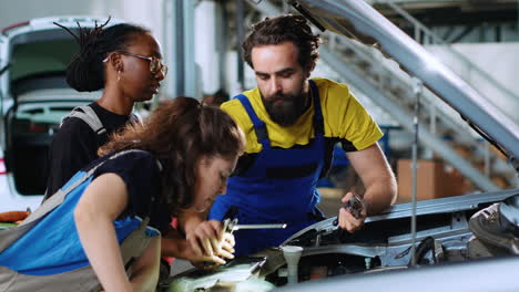 Team-of-technicians-fixing-car
