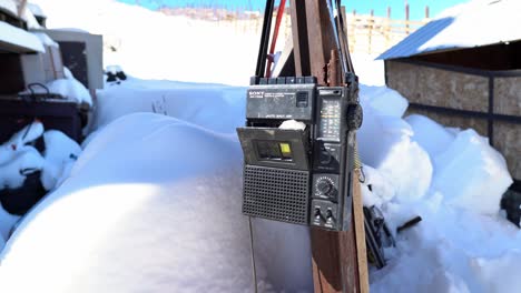 Handheld-old-Sony-portable-cassette-player-with-snow-both-in-the-opening-and-in-the-bottom,-concept-of-oblivion-in-Farellones-Chile