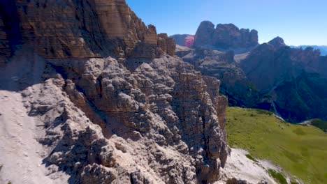 FPV-drone-diving-a-limestone-rock-wall-Tre-Cime-di-Lavaredo-mountain-at-Dolomites,-Veneto-region,-Italian-Alps
