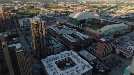 Drone-shot-around-the-sunlit-Minute-maid-Park,-golden-hour-in-Houston,-Texas,-USA