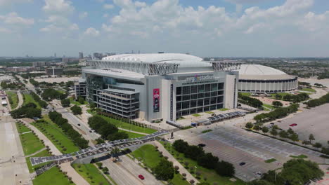 Drone-shot-circling-the-NRG-stadium,-sunny,-summer-day-in-Houston,-Texas,-USA