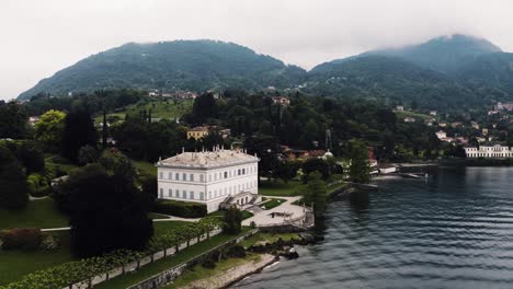 Aerial-view-of-the-Villa-Melzi-D'Eril-sitting-on-Lake-Como's-shore-in-Italy