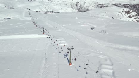 Aerial-view-dolly-in-establishing-of-the-main-ski-lift-of-the-Farellones-park-in-Chile-completely-filled-with-snow