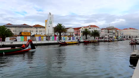 Tourists-enjoy-a-traditional-Moliceiro-boat-trip-through-the-canal-of-Aveiro