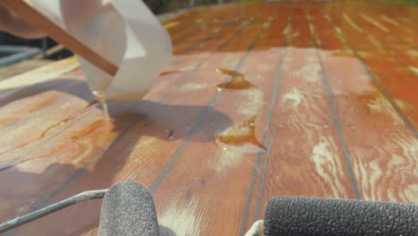 Pouring-epoxy-over-fiberglassed-planked-boat-roof