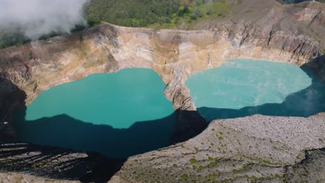 An-Aerial-View-Shot-Of-Blue-Volcanic-Crater-Lakes-On-A-Hilltop-With-A-Forest