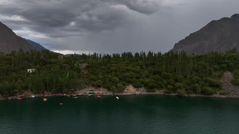 Arieal-Footage-of-drone-over-the-lake-with-deep-blue-water-with-lush-green-trees-on-the-bank-upper-kachura-lake-Skarduu