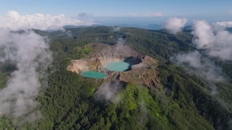 An-Aerial-Shot-Of-Blue-Volcanic-Crater-Lakes-On-A-Hilltop-With-A-Large-Forest