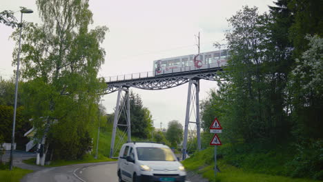 Tram-moving-over-a-bridge-above-a-road