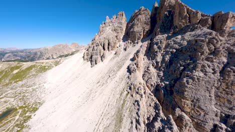 FPV-drone-flying-around-Tre-Cime-di-Lavaredo-mountain-at-Dolomites,-Veneto-region,-Italian-Alps