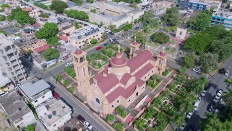 Aerial-orbiting-shot-of-ancient-cathedral-in-San-Cristobal-City-on-Dominican-Republic-at-summer-day