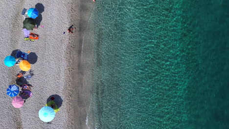 Aerial-top-down-view-static-of-Manilva-Marbella-beach,-turquoise-water-in-Sotogrande,-luxury-vacation-relaxing-holiday-in-Malaga-Spain,-umbrellas-and-parasols,-copy-space-and-room-for-text,-4K-shot