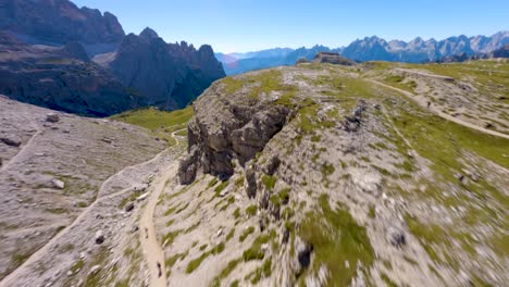 FPV-drone-flying-over-a-hiking-trail-the-famous-Tre-Cime-di-Lavaredo-mountain-at-Dolomites,-Veneto-region,-Italian-Alps