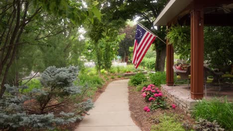 static-shot-of-a-walking-path-in-the-front-yard-of-a-home-with-a-Betsy-Ross-American-flag