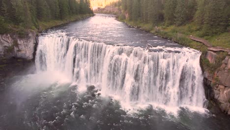 Drone-Aerial-close-up-of-the-Upper-Mesa-Falls,-a-thunderous-curtain-of-water-–-as-tall-as-a-10-story-building-Near-Island-Park,-and-Ashton,-Idaho