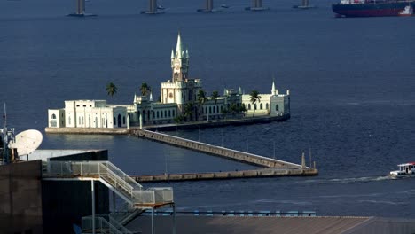 Historic-Ilha-Fiscal-island-customs-building,-static-shot-of-slow-boat-leaving-Guanabara-Bay-Rio-de-Janeiro