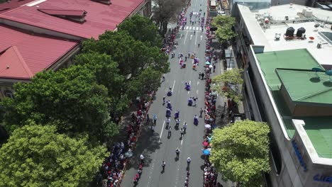 Costa-Rican-Independence-Day-Parade-High-Drone-Shot-Over-Marching-Bands-and-Children-Dancing-in-Traditional-Clothing