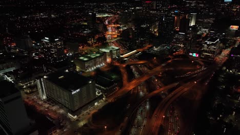Panoramic-aerial-view-of-Downtown-Atlanta-freeway-traffic-movement-at-night