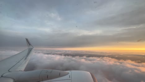 Ryanair-plane-flying-over-the-clouds-at-sunset