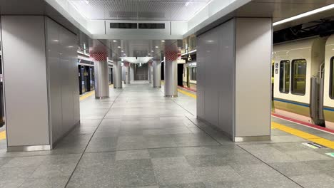 Panning-shot-showing-trains-waiting-at-an-empty-Osaka-Underground-train-Station