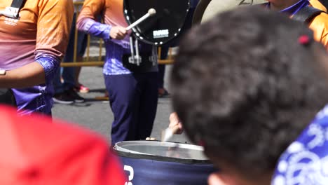 Close-Up-Shot-of-Marching-Band-Drummer-Through-Crowd-During-Costa-Rica-Independence-Day-Parade