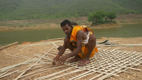 South-Asian-carpenters-weaving-the-bamboo-roof,-Bamboo-weaving