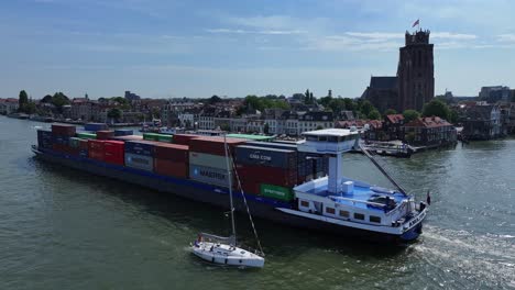 Vessel-the-Amazone-navigates-past-a-small-yacht-on-the-Oude-Maas-river