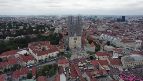 Aerial-view-of-Zagreb-cathedral-with-twin-spires-under-construction,-Kaptol
