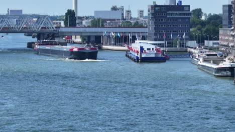 Futuro-container-vessel-navigates-it’s-way-past-another-ship-at-Zwijndrecht,-Netherlands